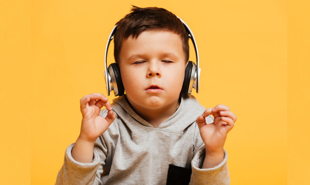 Young boy listening to music to focus